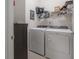 Bright laundry room with washer, dryer, and ample storage at 13305 Waterleaf Garden Cir, Riverview, FL 33579