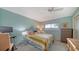 Comfortable bedroom with a large window, ceiling fan, and light blue walls at 1366 Stafford Ln # 1420, Sarasota, FL 34232