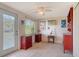 Cozy room with a ceiling fan, window and stylish red cabinet for storage at 1366 Stafford Ln # 1420, Sarasota, FL 34232