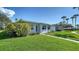 Well-maintained exterior with lush green lawn and mature shrubs at 1366 Stafford Ln # 1420, Sarasota, FL 34232