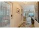 Welcoming foyer with tile flooring, a decorative rug, and views of the living area at 1366 Stafford Ln # 1420, Sarasota, FL 34232