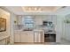 Bright kitchen showcasing white cabinetry, modern appliances, and tile flooring at 1366 Stafford Ln # 1420, Sarasota, FL 34232