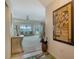 Foyer view of the living room with a ceiling fan and sliding glass doors to a porch at 1366 Stafford Ln # 1420, Sarasota, FL 34232