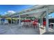 Poolside covered area with tables and chairs, providing a shaded space for relaxation at 1366 Stafford Ln # 1420, Sarasota, FL 34232