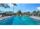 Community pool surrounded by a fence and offering ample seating for residents at 1366 Stafford Ln # 1420, Sarasota, FL 34232