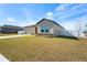 Front view of a light beige house with stone accents at 1418 Bluejack Oak Dr, Seffner, FL 33584