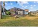 Beautiful backyard featuring a screened lanai, well-maintained lawn, and lush landscaping at 1893 Riveredge Dr, Tarpon Springs, FL 34689