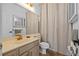 Well-maintained bathroom featuring a vanity with ample lighting and a shower with modern fixtures at 1893 Riveredge Dr, Tarpon Springs, FL 34689