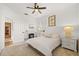 Well-lit bedroom featuring a ceiling fan and a charming fireplace, creating a warm and cozy ambiance at 1893 Riveredge Dr, Tarpon Springs, FL 34689