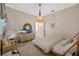 Cozy bedroom with neutral tones, a unique light fixture, and a stylish dresser with a fish tank at 1893 Riveredge Dr, Tarpon Springs, FL 34689