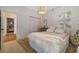 Inviting bedroom showcasing soft textures, a patterned rug, and a view into an adjacent room at 1893 Riveredge Dr, Tarpon Springs, FL 34689