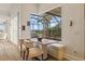 Cozy dining space with a banquette seat and large window overlooking the screened-in pool at 1893 Riveredge Dr, Tarpon Springs, FL 34689