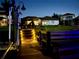 Nighttime view of a boat dock featuring a bench and stairway lighting at 1893 Riveredge Dr, Tarpon Springs, FL 34689