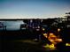 Nighttime view of a lit-up pathway leading to a boat dock on the water at 1893 Riveredge Dr, Tarpon Springs, FL 34689