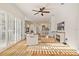 Sunlit living room boasts hardwood floors, fireplace, and open layout flowing into the kitchen at 1893 Riveredge Dr, Tarpon Springs, FL 34689