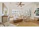 Bright living room featuring hardwood floors, modern furniture, fireplace, and natural light at 1893 Riveredge Dr, Tarpon Springs, FL 34689