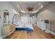 Comfortable main bedroom featuring wood floors, tray ceiling, and elegant furniture at 1893 Riveredge Dr, Tarpon Springs, FL 34689