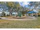 Community playground with modern equipment, covered seating, and mature shade trees at 1893 Riveredge Dr, Tarpon Springs, FL 34689