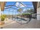 Fenced pool and screened enclosure provides safety and relaxation, and offers serene waterfront views at 1893 Riveredge Dr, Tarpon Springs, FL 34689