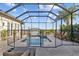 The screened-in pool boasts a safety fence, waterfront views, and an inviting outdoor space at 1893 Riveredge Dr, Tarpon Springs, FL 34689