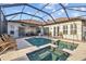 Private pool with spa, fully screened in, surrounded by a patio and lush landscaping at 1893 Riveredge Dr, Tarpon Springs, FL 34689