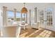 Bright sitting room featuring hardwood floors, a modern light fixture and tranquil water views at 1893 Riveredge Dr, Tarpon Springs, FL 34689