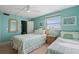 Bright bedroom featuring two twin beds and ocean-themed art at 19725 Gulf Blvd # 405, Indian Shores, FL 33785