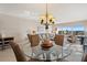 Bright dining area with glass table and waterfront view at 19725 Gulf Blvd # 405, Indian Shores, FL 33785