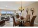 Dining area with glass-top table, four chairs, and water views at 19725 Gulf Blvd # 405, Indian Shores, FL 33785