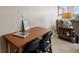 Small home office with a wood desk and two black chairs at 19725 Gulf Blvd # 405, Indian Shores, FL 33785