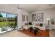 Living room with beige sectional sofa and sliding glass doors to patio at 2071 Hallier Cv, Wesley Chapel, FL 33543