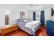 Bedroom with wooden floors and blue curtains at 210 Lee St, Oldsmar, FL 34677