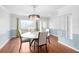 Formal dining room with hardwood floors and large window at 210 Lee St, Oldsmar, FL 34677