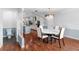 Bright dining room with hardwood floors and a view into the kitchen at 210 Lee St, Oldsmar, FL 34677