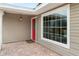 Inviting front porch with red door and large window at 210 Lee St, Oldsmar, FL 34677