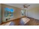 Bedroom with wood floors, ceiling fan, and large window at 2363 Israeli Dr # 61, Clearwater, FL 33763