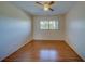 Simple bedroom with wood-look floors and a window at 2363 Israeli Dr # 61, Clearwater, FL 33763