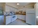 White kitchen with granite countertops and appliances at 2363 Israeli Dr # 61, Clearwater, FL 33763