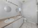 Bathroom with double vanity and shower at 24156 Buckingham Way, Punta Gorda, FL 33980