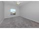 Bedroom with gray walls, gray carpet, and a window at 24156 Buckingham Way, Punta Gorda, FL 33980