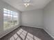 Spacious bedroom with gray walls, gray carpet, and a large window at 24156 Buckingham Way, Punta Gorda, FL 33980