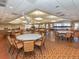 Large community room with tables and chairs, ideal for events at 24156 Buckingham Way, Punta Gorda, FL 33980