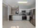 Bright kitchen featuring stainless steel appliances and white cabinetry at 24156 Buckingham Way, Punta Gorda, FL 33980