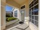 Covered porch with white door and windows, view of backyard at 24156 Buckingham Way, Punta Gorda, FL 33980