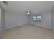 Large bedroom with window, carpet, and ceiling fan at 2421 Lancaster Dr, Sun City Center, FL 33573