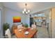 Bright dining area with wood table and view into kitchen at 2421 Lancaster Dr, Sun City Center, FL 33573