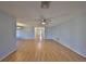 Spacious living room with light-grey walls and light-brown laminate floors at 2421 Lancaster Dr, Sun City Center, FL 33573