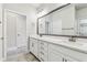 Bathroom featuring a double vanity with white cabinets, quartz countertops, and large mirror at 2511 N Grady Ave # 23, Tampa, FL 33607