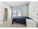 This bedroom features neutral walls, carpet, and two windows dressed with modern white horizontal blinds at 2511 N Grady Ave # 23, Tampa, FL 33607