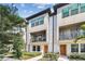 Modern townhome featuring a clean facade, cozy balcony and landscaped walkway at 2511 N Grady Ave # 23, Tampa, FL 33607